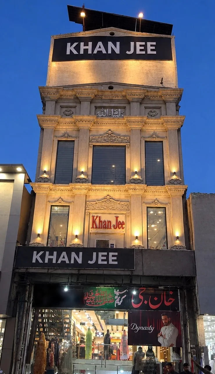 The Khan Jee Center on Civil Quarters Road, Sheikhupura, lit at dusk