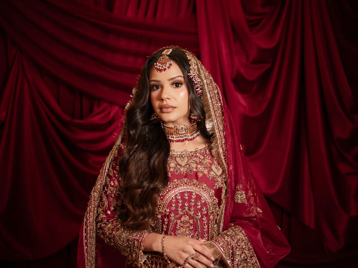 Bride in a red embroidered bridal dress and jewellery