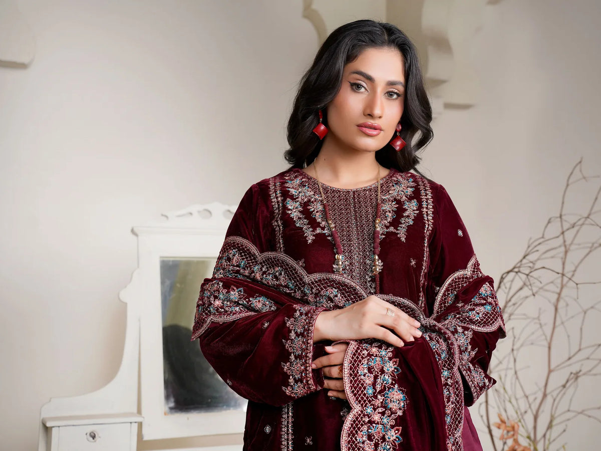 Woman wearing a maroon embroidered velvet shawl